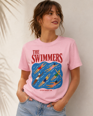 Woman wearing The Swimmers pink graphic T-shirt by Made Her Way