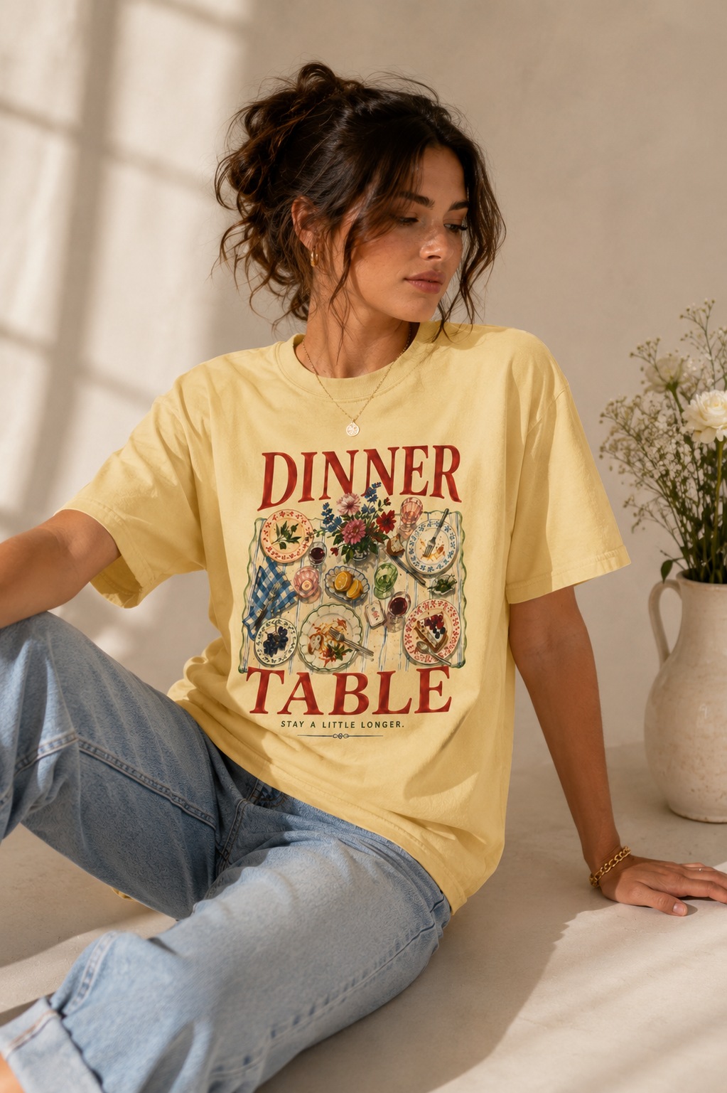 Woman styling Dinner Table yellow graphic tee with jeans